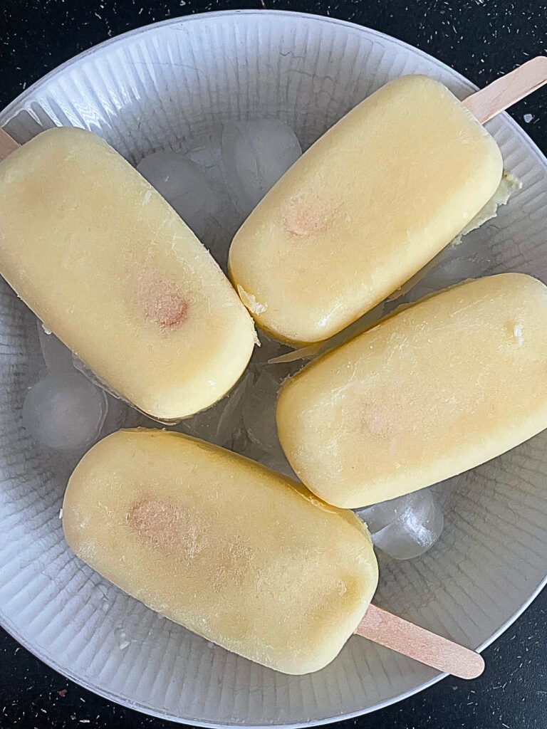 4 popsicles on a ice in a white plate