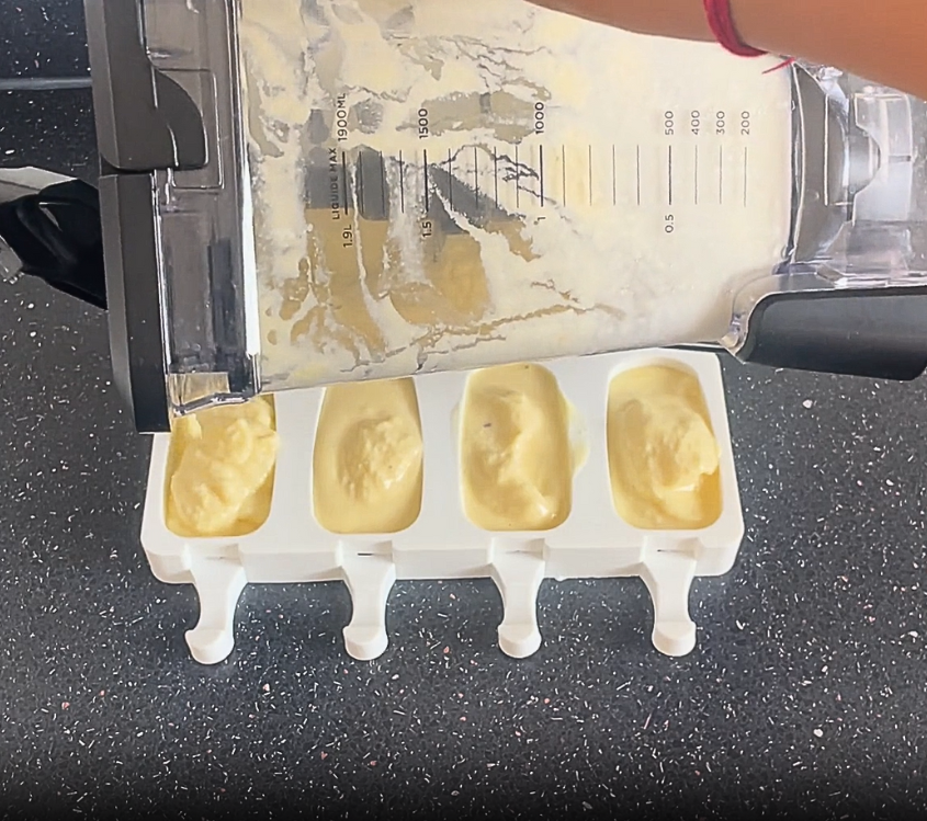 pouring pineapple sorbet mixture into silicone popsicle mould