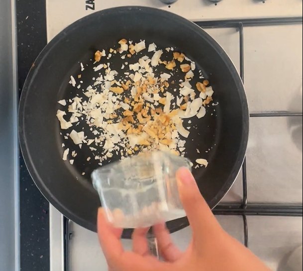 Adding chopped walnuts to hot non-stick frying pan