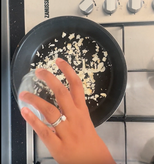 Adding flaked coconut to hot non-stick frying pan