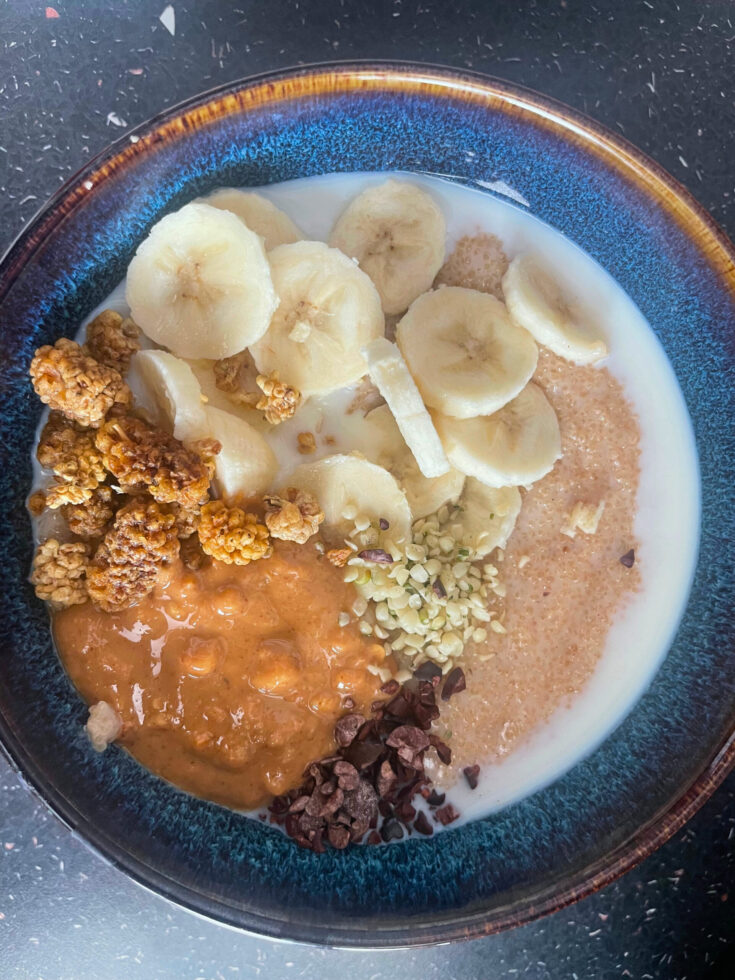 Amaranth porridge in bowl with all the toppings