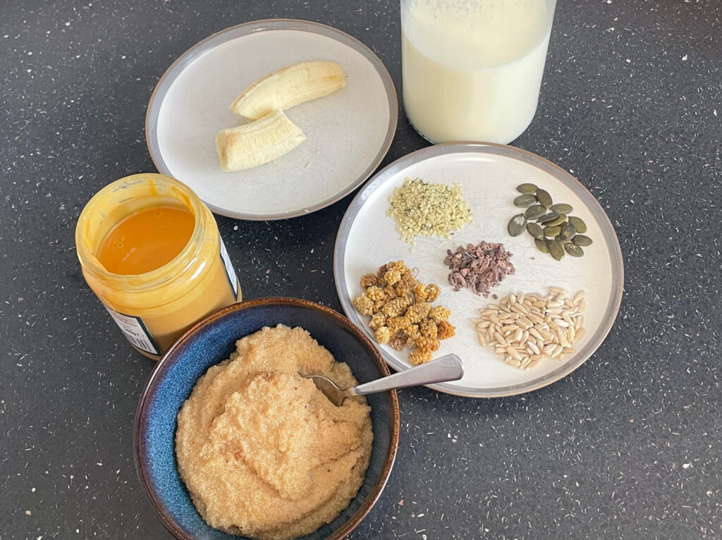 Amaranth porridge in bowl with optional toppings