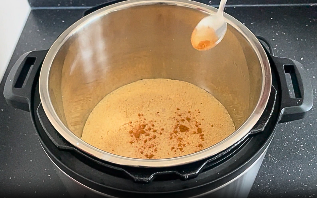 Sweet cinnamon being added to the instant pot