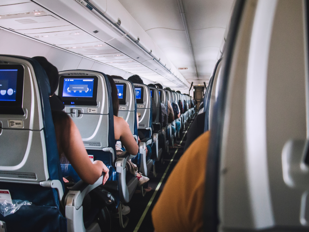 rows of seats on a flight where can see the displays behind each seat