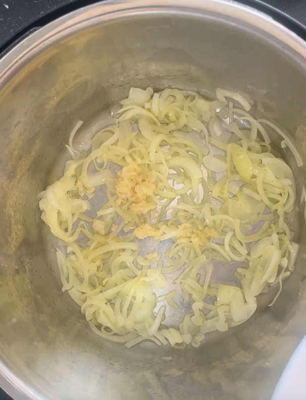 Add in minced garlic to softened onions in Instant Pot