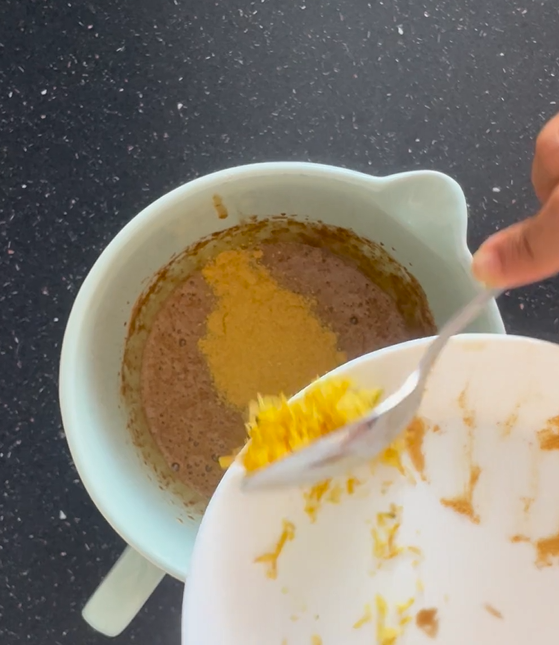 Adding lemon zest to beaten mixture