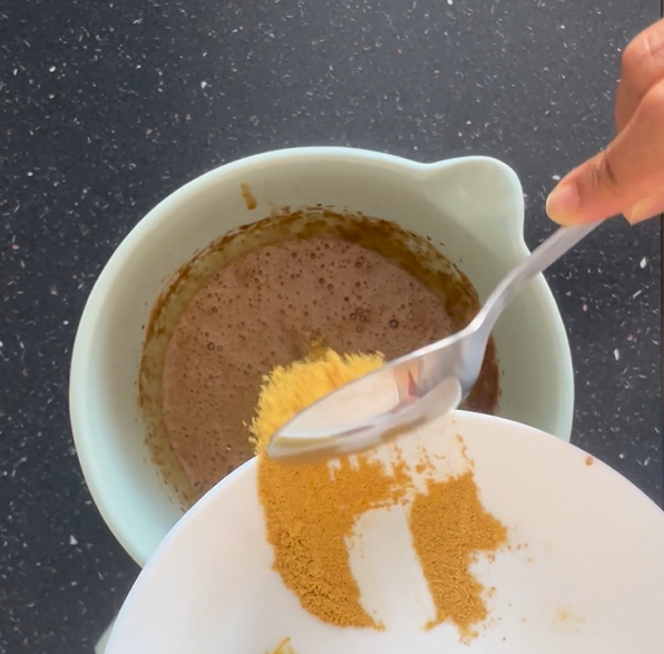 Adding orange zest to beaten mixture