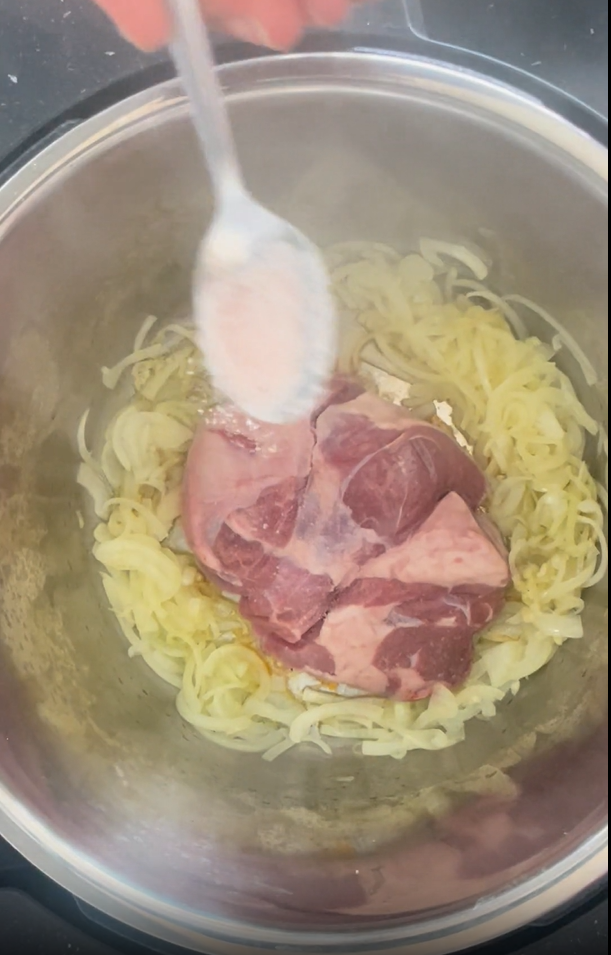 Adding Himalayan pink salt to unseasoned side of lamb that is in the Instant Pot