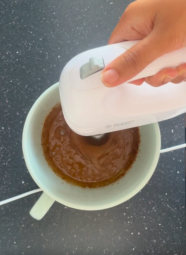 Beating in coconut sugar with handheld beater