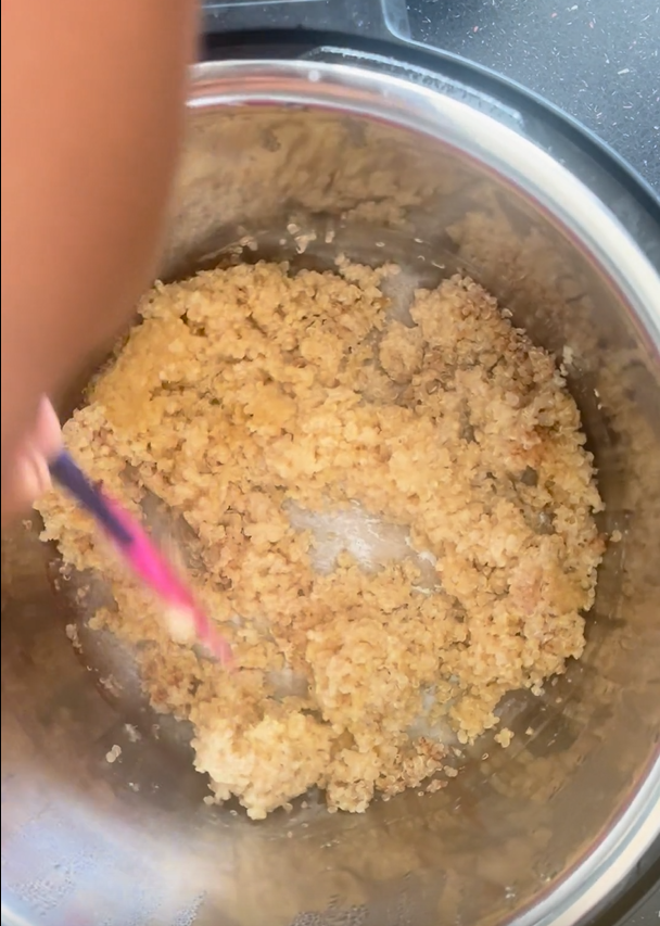 Cooked quinoa in the instant pot that is being mixed so can see the texture