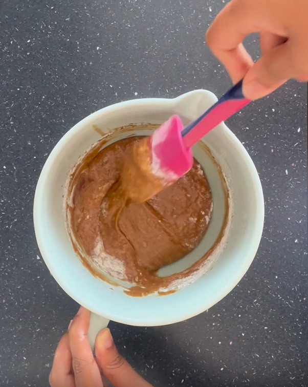 Folding in half of the dry ingredients and stopping when most of the dry ingredients is incorporated