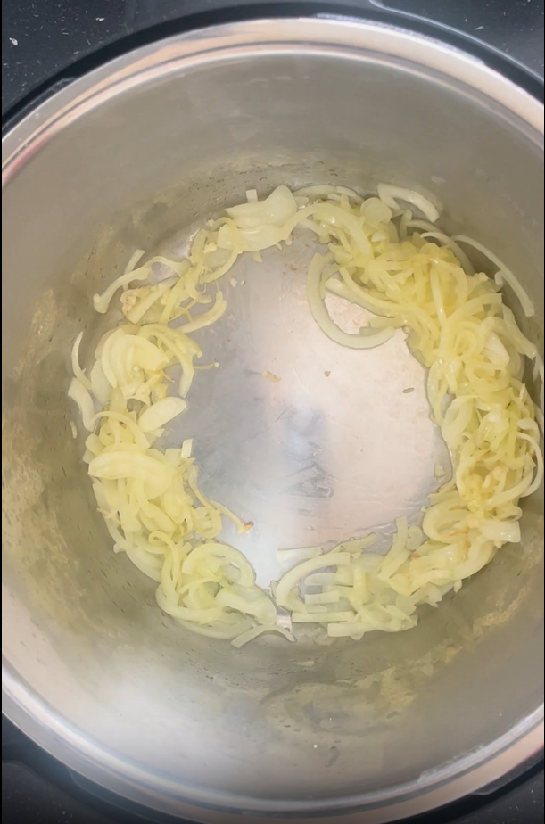 Mix garlic and onions together then move the mixture to the sides of the Instant Pot to create a well