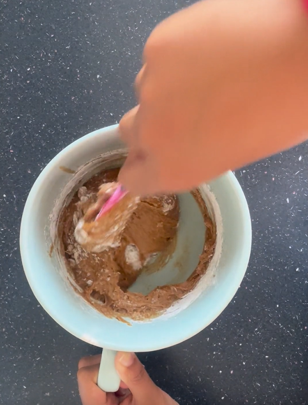 Mixing in the second half of the dry ingredients being sure to mix from under the batter as well so all the dry ingredients are incorporated