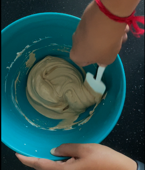 Mixing powdered coconut sugar and whipped cream cheese together