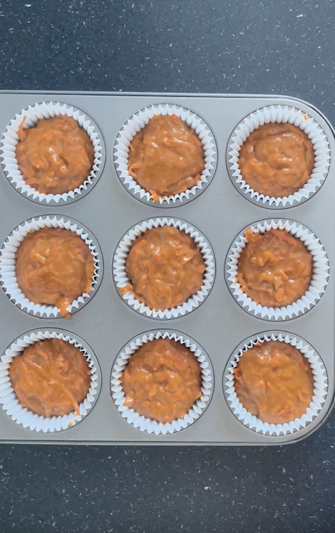 Muffin tray filled with carrot cake muffin batter