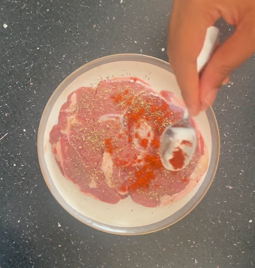 Seasoning lamb with smoked paprika on saucer