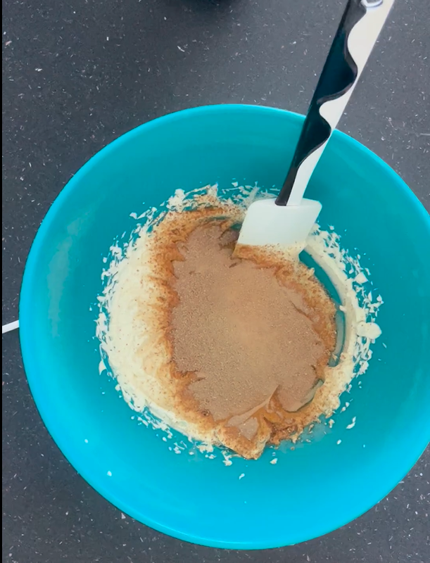 Sieved coconut sugar in bowl with whipped cream cheese