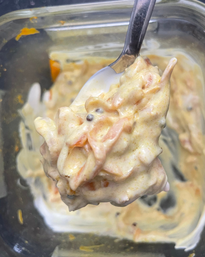 Carrot raita on a spoon close up