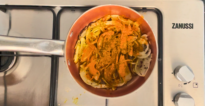 Turmeric added to the pot with the onions and spices